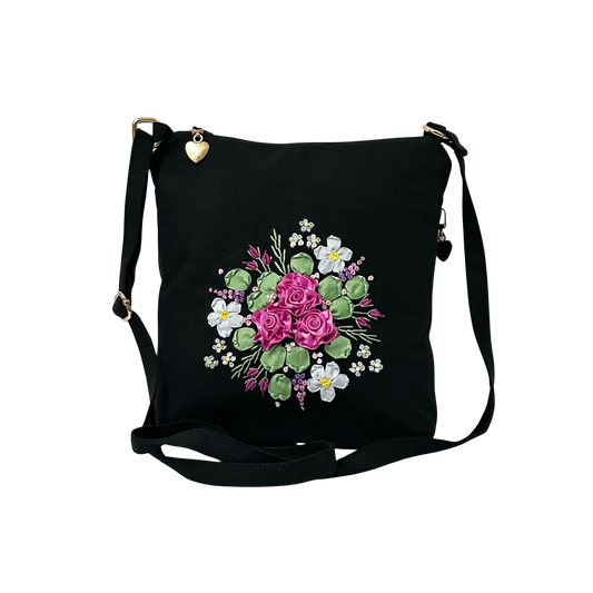 Black bag with floral design on a white background