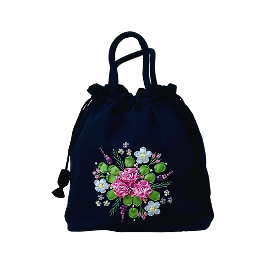 Black drawstring bag with light pink embroidered roses .