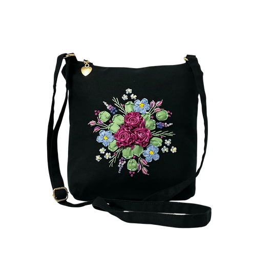 Black bag with floral embroidery on a white background